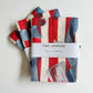 christmas tea towel with blue bows, cherries and stars